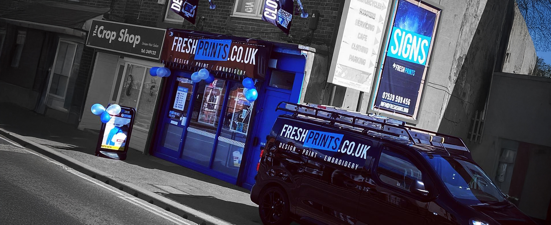 Street view of a print and embroidery shop named Fresh Prints